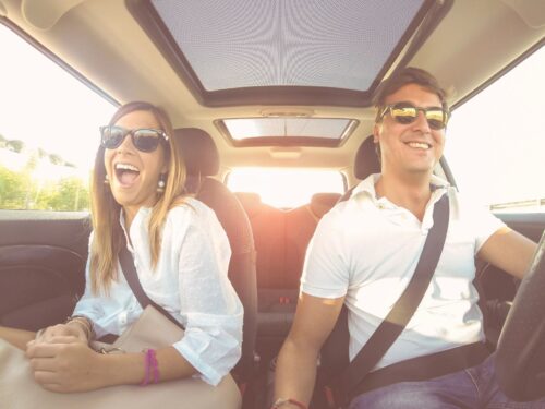 woman distracts man while he is driving.